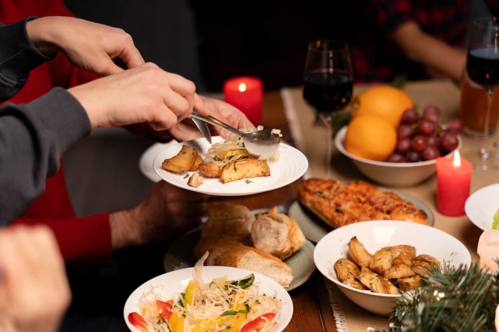 A plate divided, showing a balanced selection of half vegetables and a small portion of holiday food, illustrating mindful eating.